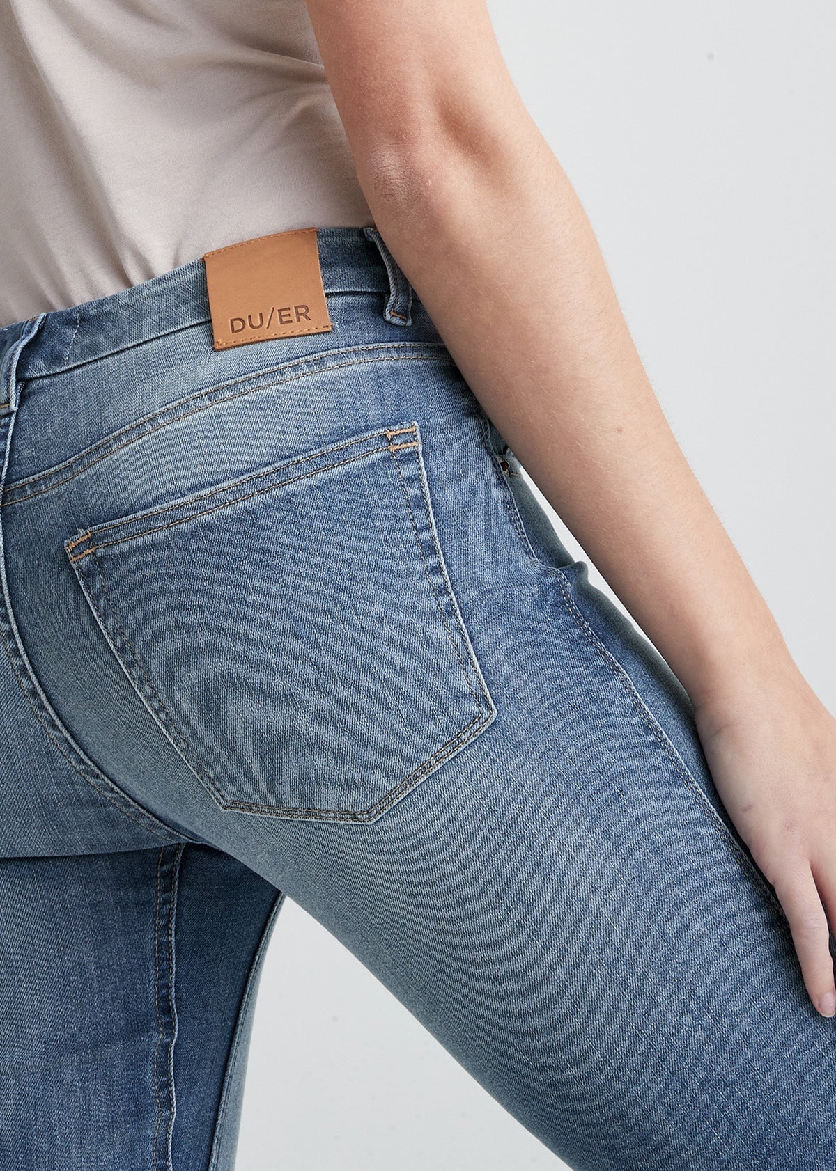 womens light blue mid rise skinny stretch jeans back pocket and gusset detail